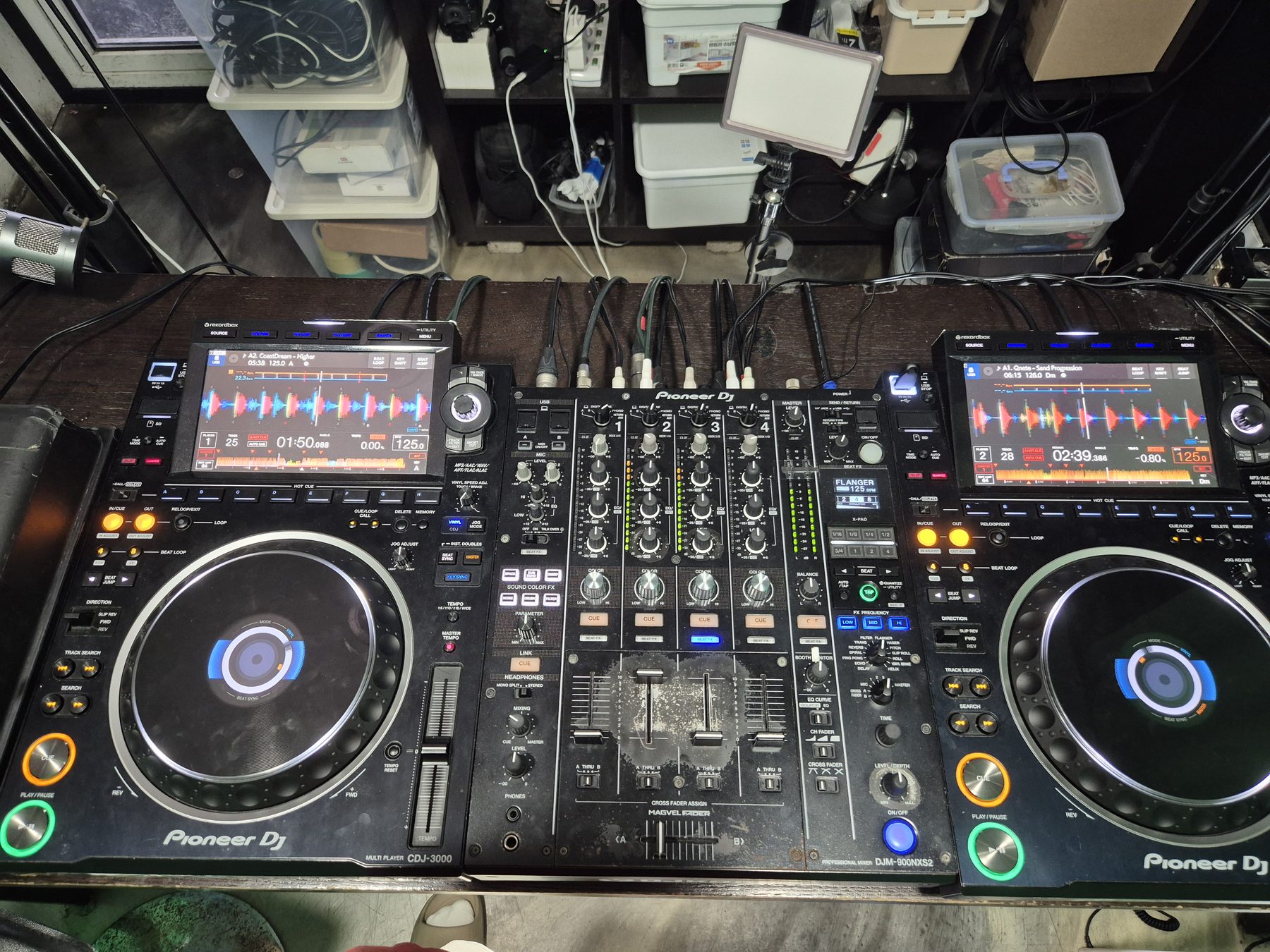Home practice setup with two Pioneer CDJ players and a DJM mixer on a desk.